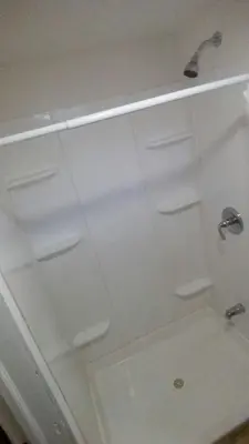 a bathroom with a shower with white walls at Budget Motor Inn- Stony Point in Stony Point