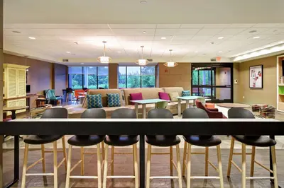 a lobby with a table and chairs and a couch at Home2 Suites Mechanicsburg in Mechanicsburg