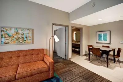 a living room with a couch and a table at Home2 Suites Mechanicsburg in Mechanicsburg