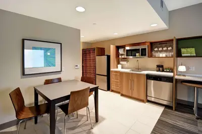 a kitchen and dining room with a table and chairs at Home2 Suites Mechanicsburg in Mechanicsburg