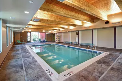 a large pool with a wooden ceiling and a large room at Home2 Suites Mechanicsburg in Mechanicsburg