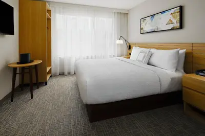 a hotel room with a large bed and a window at TownePlace Suites by Marriott New York Manhattan/Times Square in New York