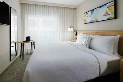 a bedroom with a large white bed and a window at TownePlace Suites by Marriott New York Manhattan/Times Square in New York