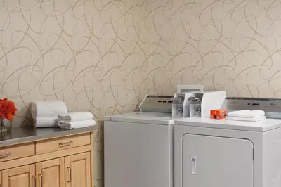 a laundry room with a washer and dryer at Days Inn by Wyndham Reading Wyomissing in Reading