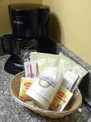 a basket of food on a counter next to a coffee maker at Days Inn by Wyndham Reading Wyomissing in Reading