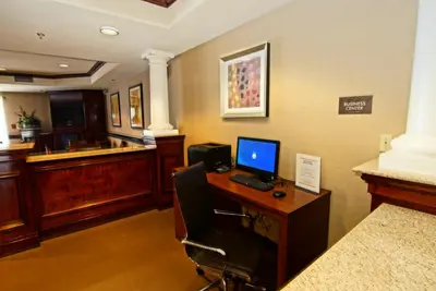 a office with a desk with a computer on it at Comfort Suites Near University in North Brunswick