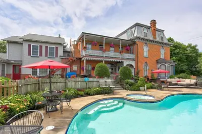 a house with a swimming pool in front of a house at Greystone Manor Bed & Breakfast in Bird in Hand