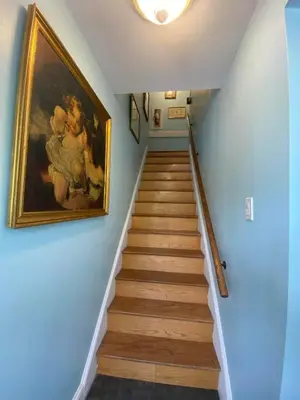 a stairway with a painting on the wall at Greystone Manor Bed & Breakfast in Bird in Hand