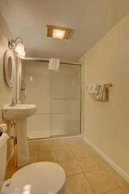 a bathroom with a shower and a toilet and a sink at Greystone Manor Bed & Breakfast in Bird in Hand