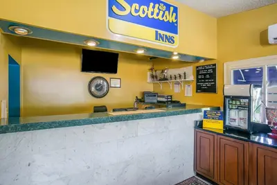 a fast food restaurant with a counter with a cashier at Scottish Inns Harrisburg-Hershey South in New Cumberland