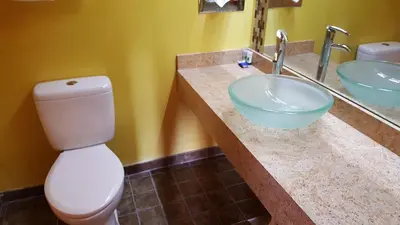 a bathroom with a toilet and a sink at Scottish Inns Harrisburg-Hershey South in New Cumberland