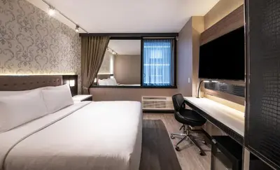 a hotel room with a bed and a desk at Aliz Hotel Times Square in New York