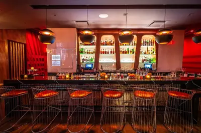 a bar with orange stools in a restaurant at Aliz Hotel Times Square in New York