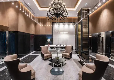 a lobby with chairs and a table and a chandelier at Aliz Hotel Times Square in New York