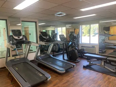 a gym with several treadmills and elliptical machines at Sleep Inn Carlisle South in Carlisle