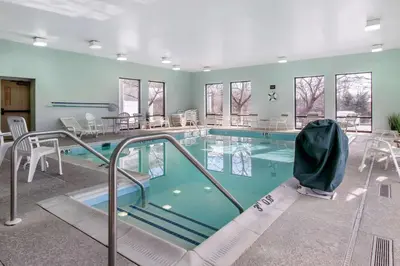 a large swimming pool with chairs and tables at Sleep Inn Carlisle South in Carlisle