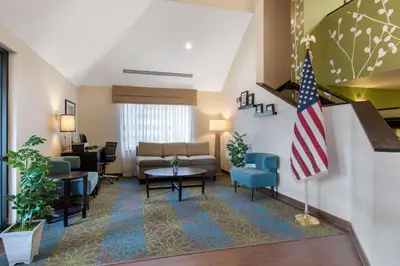 a living room with an american flag in a hotel room at Sleep Inn Carlisle South in Carlisle