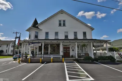 a white building with a store in a parking lot at Lizard Creek Inn in Andreas