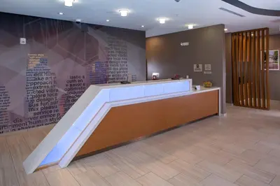 a lobby with a counter and a wall with writing on it at Springhill Suites By Marriott Newark Downtown in Newark