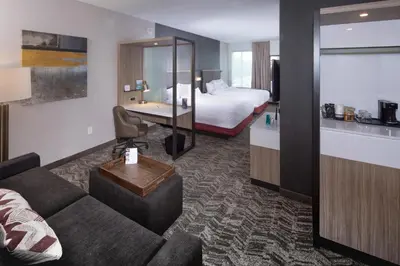 a hotel room with a couch and a bed at Springhill Suites By Marriott Newark Downtown in Newark