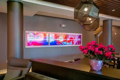 a dining room with a table with flowers on it at Springhill Suites By Marriott Newark Downtown in Newark
