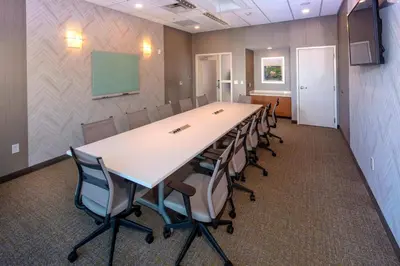 a conference room with a long table and chairs at Springhill Suites By Marriott Newark Downtown in Newark