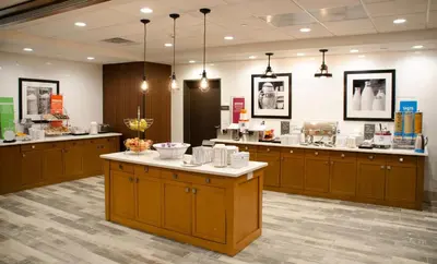 a store with wooden cabinets and a counter in a room at Hampton Inn Lebanon in Lebanon