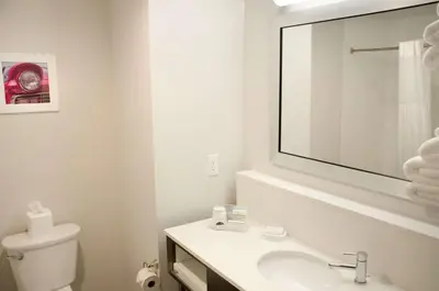 a white bathroom with a sink and a mirror at Hampton Inn Lebanon in Lebanon