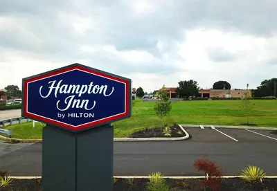 a sign for a hampton inn in a parking lot at Hampton Inn Lebanon in Lebanon