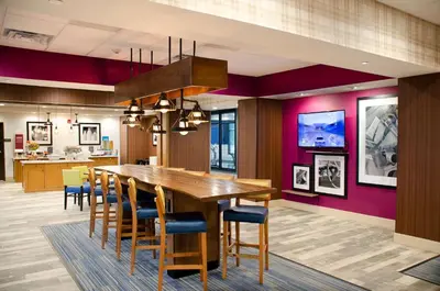 a dining room with a large wooden table and chairs at Hampton Inn Lebanon in Lebanon