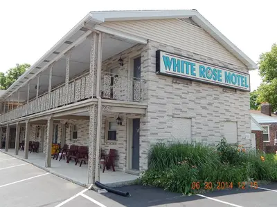 a white house with a sign that reads white rose motel at White Rose Motel - Hershey in Hershey