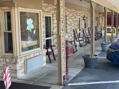 a building with a window with a flower painted on it at White Rose Motel - Hershey in Hershey