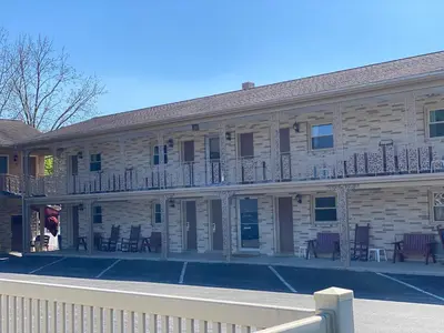 a building with tables and chairs in a parking lot at White Rose Motel - Hershey in Hershey