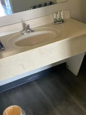 a sink in a bathroom with a counter at White Rose Motel - Hershey in Hershey