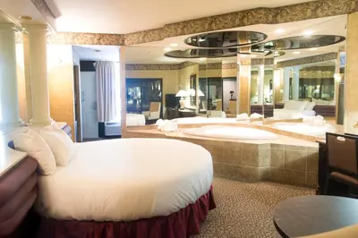 a bedroom with a large bed and a bath tub at Paradise Stream Resort in Cresco