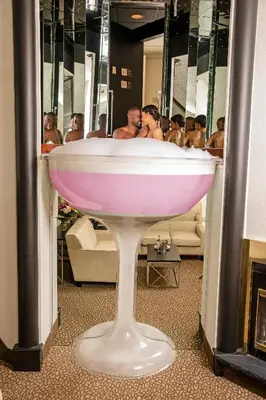 a group of men in a bath tub in a bathroom at Paradise Stream Resort in Cresco