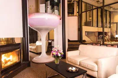 a living room with a large wine glass in front of a fireplace at Cove Haven Resort in Lakeville