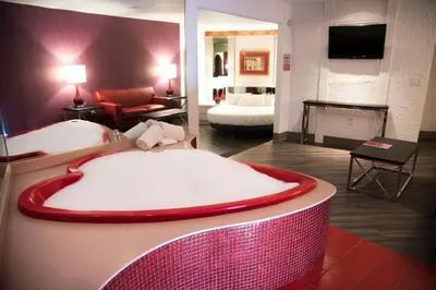 a hotel room with a large bed and a living room at Cove Haven Resort in Lakeville
