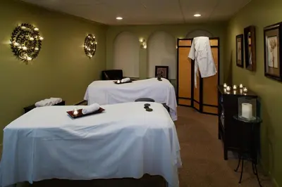 a room with two beds with white sheets at Cove Haven Resort in Lakeville