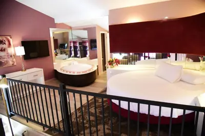 a bedroom with a large bed and a bath tub at Cove Haven Resort in Lakeville
