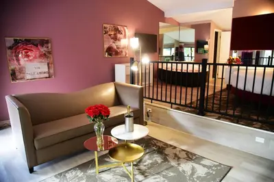 a living room with a couch and a table with a vase of flowers at Cove Haven Resort in Lakeville