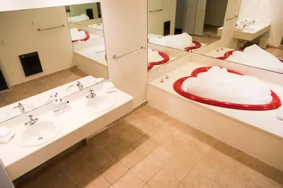 a bathroom with two sinks and two mirrors at Cove Haven Resort in Lakeville