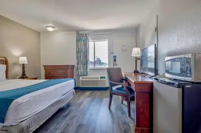 a hotel room with a bed and a desk and a television at Motel 6 Harrisburg PA Near PA Expo Center in Harrisburg