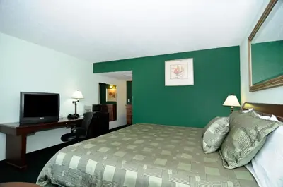 a hotel room with a bed and a desk at Motel 6 Harrisburg PA Near PA Expo Center in Harrisburg