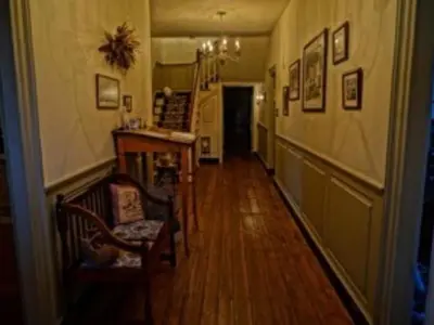 a hallway with two chairs and a table in a room at Brownstone Colonial Inn in Reinholds