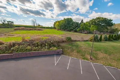 an aerial view of a parking lot with a field at Motel 6-Drums in Drums
