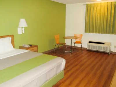 a hotel room with a bed and a table and chairs at Motel 6-Drums in Drums