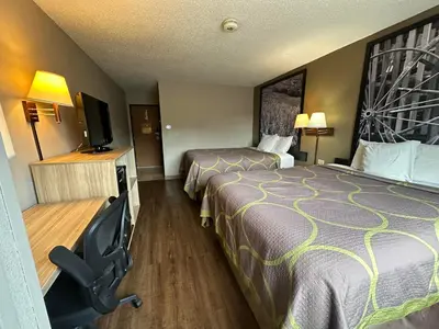 a hotel room with two beds and a desk with a chair at Super 8 by Wyndham Allentown Kutztown Area in Kutztown
