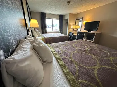 a hotel room with two beds and a television at Super 8 by Wyndham Allentown Kutztown Area in Kutztown
