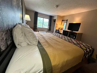 a hotel room with a large bed and a television at Super 8 by Wyndham Allentown Kutztown Area in Kutztown